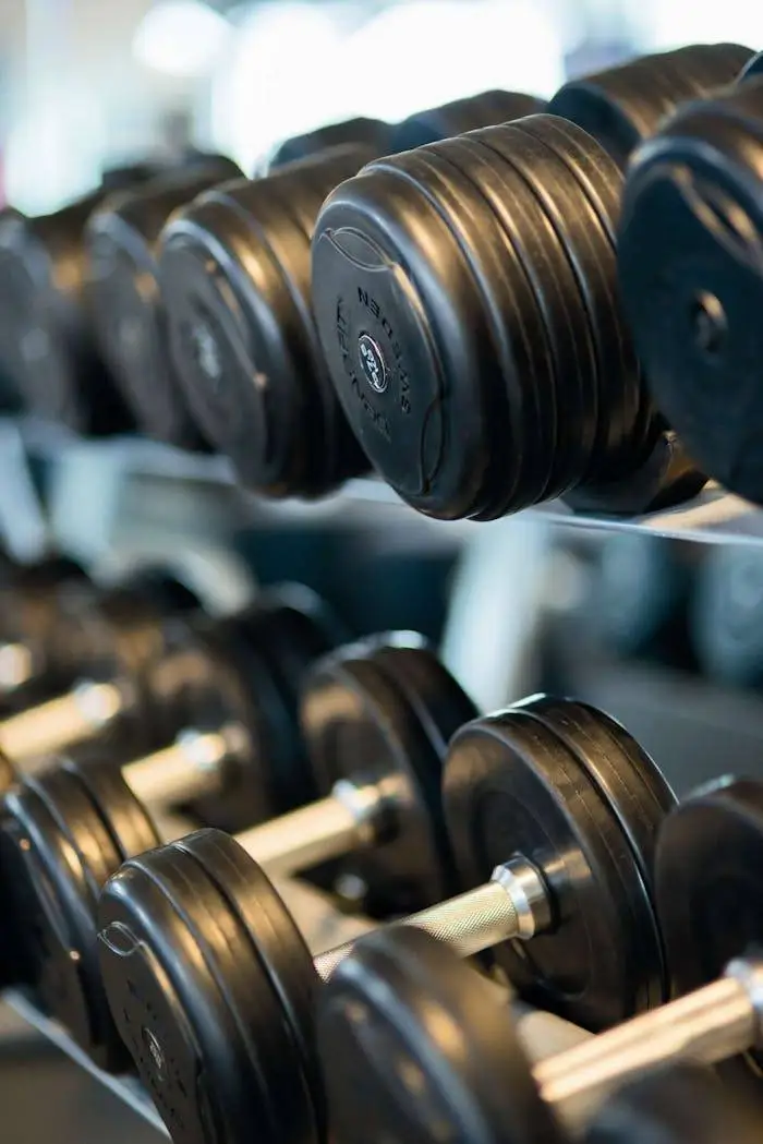 Athlete training with a dumbbell in a gym